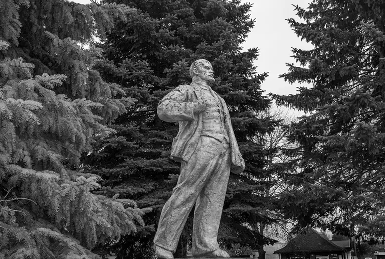 A Soviet monument (Vladimir Lenin) stands among dark fir trees — a fragment of ideology quietly aging in a landscape that has changed many times. Kaliningrad region, 03.03.2026. Photo by Oleg Klimov