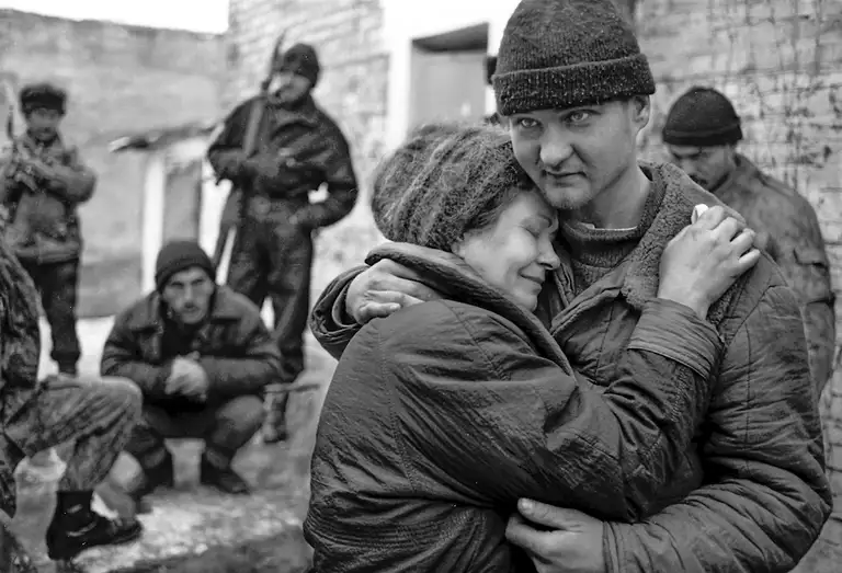 A mother found her soldier son in Chechen captivity. Shali, Chechnya, Russia. January 1994. Photo by Oleg Klimov.