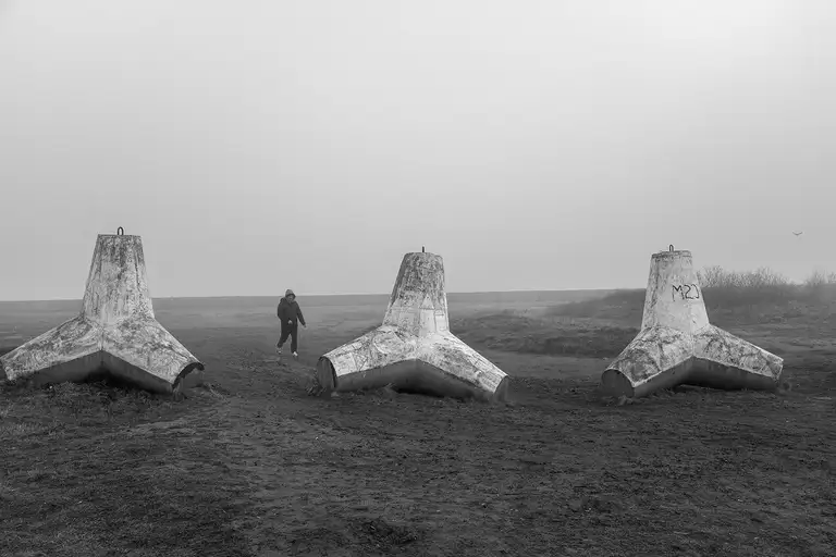 Tetrapods—massive reinforced concrete blocks shaped like four connected cones—are used to protect the shoreline from erosion and waves. Baltiysk, a Russian exclave. Photo by Oleg Klimov. April 2, 2026