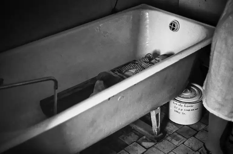 The child waits his turn while the nanny changes another child's clothes. Specialized Children's Home No. 2, which houses children with congenital malformations, postpartum injuries, and those who, according to doctors, cannot live among ordinary children. St. Michurina. Novokuznetsk. Kemerovo region. Kuzbass. Siberia. 29.05. 1981 Photo Vladimir Sokolaev/Liberty SU Archive