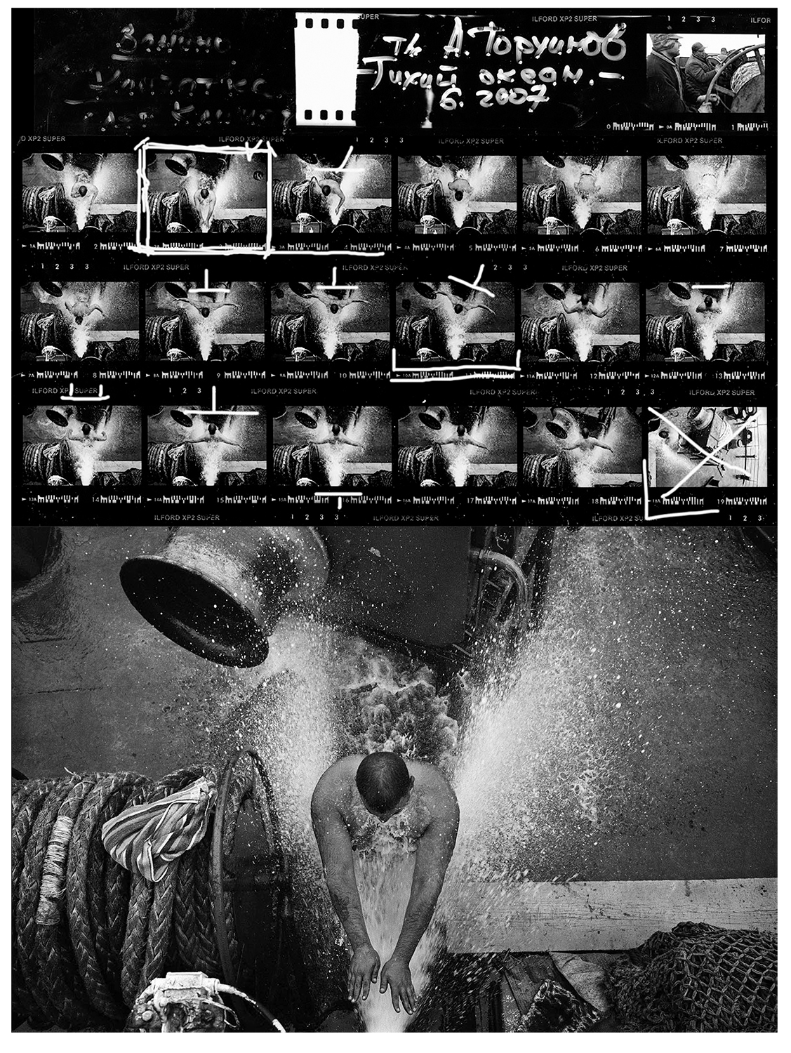 Selecting a photograph from contact sheets. The boatswain aboard the cargo ship Anatoly Torchinov takes a shower using the ship’s fire hose. Pacific Ocean, off Kamchatka, 2007. Photo by Oleg Klimov