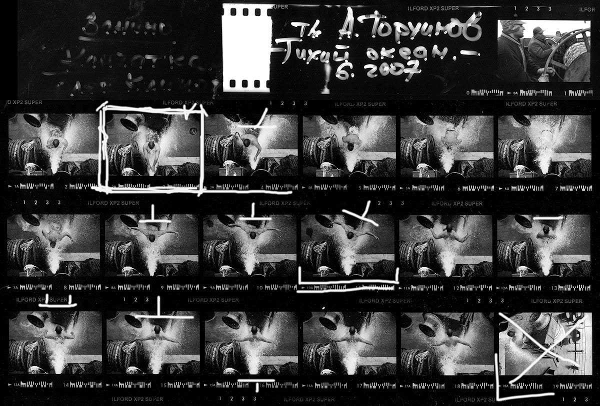Selecting a photograph from contact sheets. By Oleg Klimov